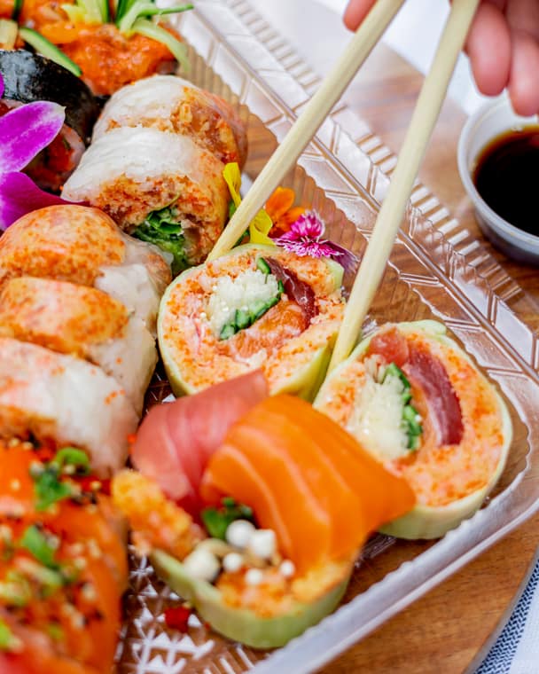 Close-up of rice-paper rolls and salmon sashimi