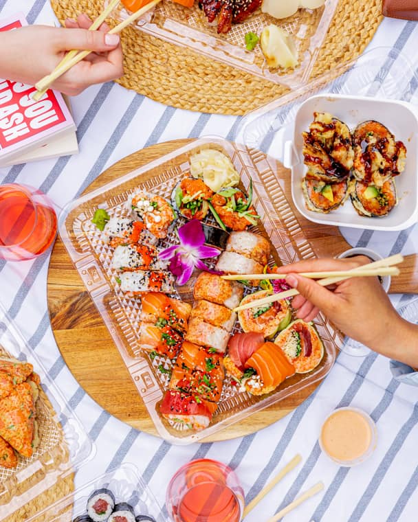 Sushi platter shared on a striped tablecloth